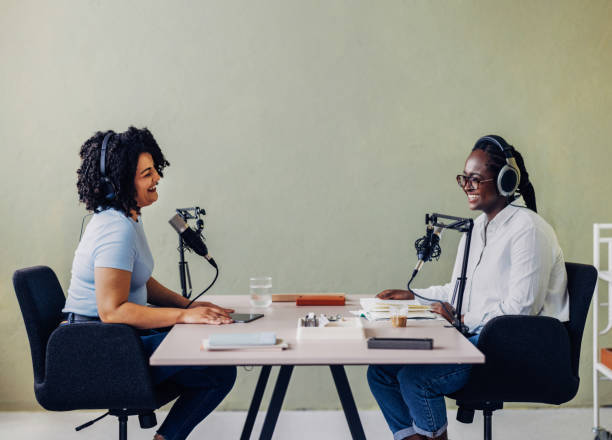 Two Women Recording a Podcast Together in a Studio
