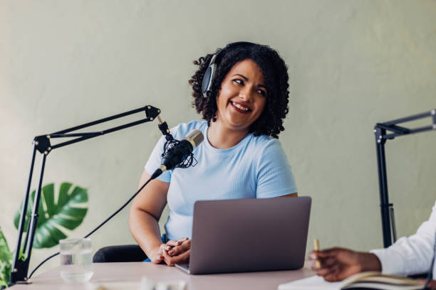 istock Smiling Woman Recording Podcast with Co-Host in Studio 2151451940