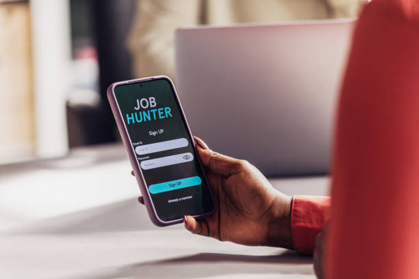 istock Professional in Red Jacket Using Job App on Smartphone 2151451963