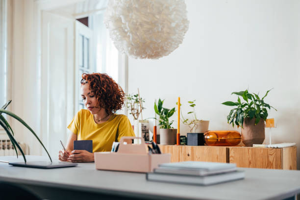 istock Young Woman Planning Her Week in a Bright Home Office 2151453348
