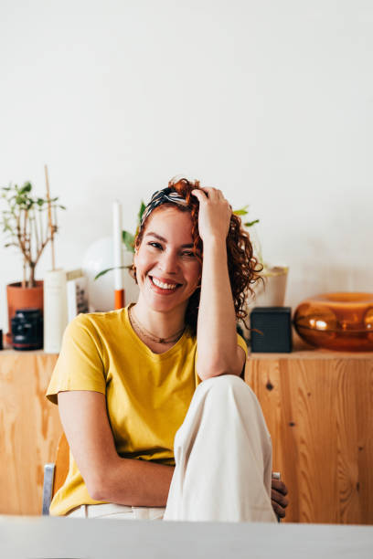 istock Happy Young Woman Smiling in a Casual Home Setting 2151453349