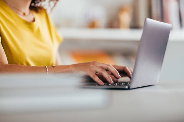 Young Woman Working Intently on Laptop in Bright Room
