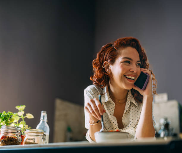 istock Happy Woman Talking on Phone During Lunch Break 2151453400