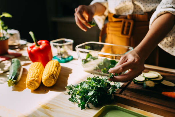 istock Woman Preparing Healthy Meal with Fresh Vegetables in Kitchen 2151453435
