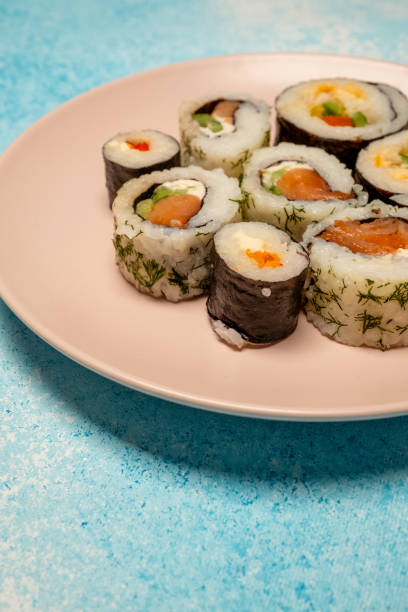 istock Philadelphia roll sushi on a 360 degree rotating table 2151454134