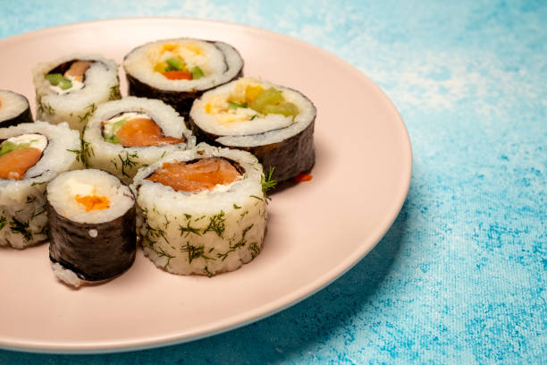 istock Philadelphia roll sushi on a 360 degree rotating table 2151454157
