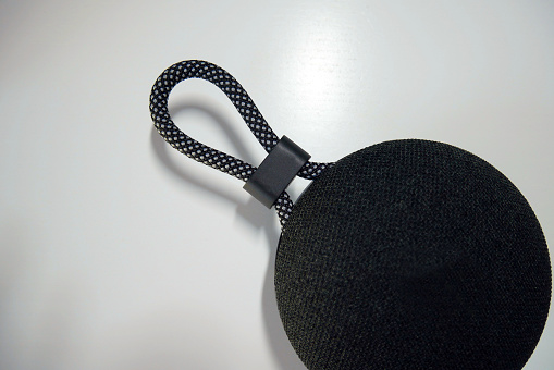 A small speaker for listening to music. Portable black speaker