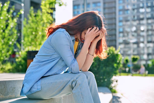 istock Upset sad unhappy young female sitting outdoor on steps 2151460193