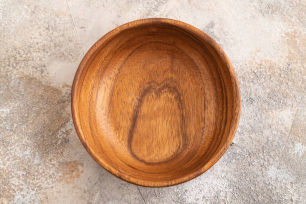 istock Empty brown wooden bowl on brown concrete. Top view, copy space 2151460426