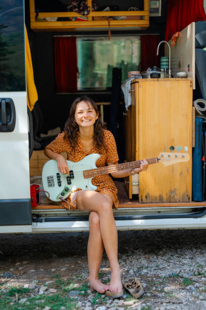 istock Woman playing electric guitar in camper van 2151464917
