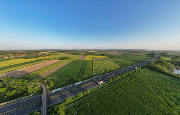 istock Sky above a road cutting through green grassland fields with windmill Wind turbines panorama drone view Hanover Wunstorf Kolenfeld Germany 2151465137