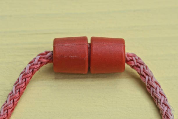 istock long red shoelaces with a plastic clip lie on a yellow table 2151465760