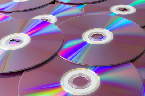 istock Rainbow reflections on a collection of compact discs. Vibrant stack of cds with iridescent reflections creating a spectrum of colors, representing data storage and digital technology. 2151465862