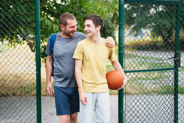 istock Father and soon standing outside with a basketball. 2151472500