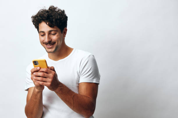 istock White man t-shirt message hipster online technology phone 2151478166