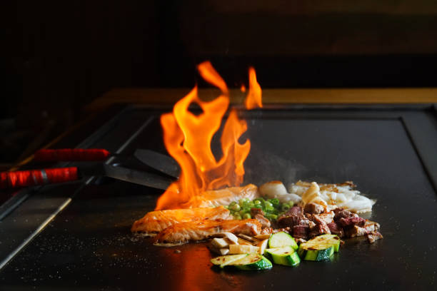 istock chef's hands with spatula over teppanyaki. Teppan show 2151479779