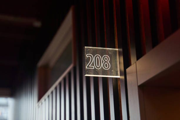 istock Glowing white room number plate in hotel 2151480484