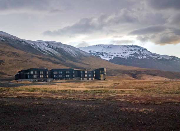 istock House under the snow-capped mountains. 2151487887