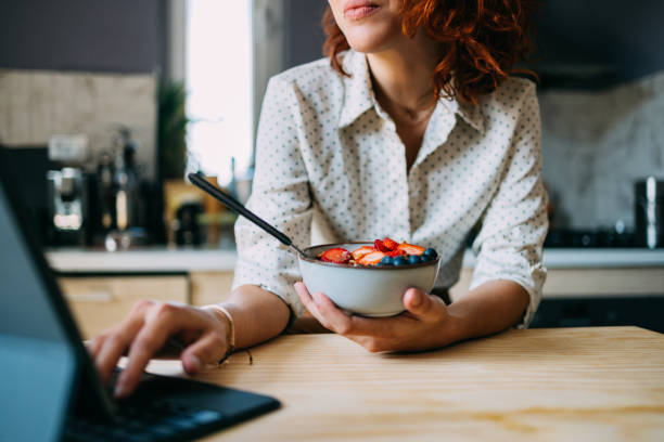 istock Young Woman Eating Healthy Breakfast While Working From Home 2151490618