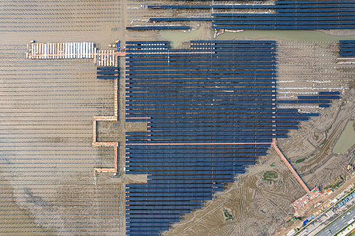 Aerial view of mudflat construction site where photovoltaic solar panels are installed