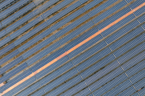 Vertical aerial view of photovoltaic solar panels on mudflat