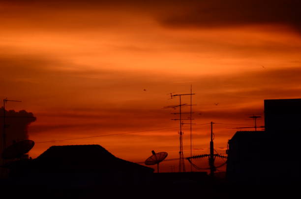 Scenic view dramatic beautiful sunset sky. Natural Sunset Sunrise on meadow silhouette shadow dark land. Vibrant dramatic sky on sunset, dawn, sunrise in Countryside. Landscape Colorful Sky At Sunset