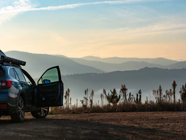 Car with door open looking at early morning mountain views