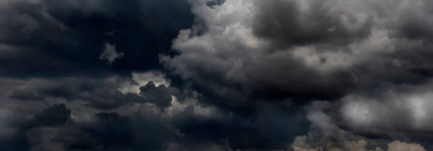 Banner Dramatic dark storm clouds black sky background. Dark thunderstorm clouds rainny season. Panorama Meteorology danger windstorm disasters climate. Dark cloudscape storm cloud with copy space.