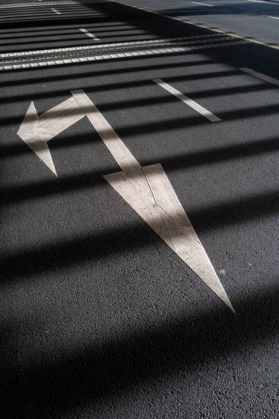 Light and shadow on traffic signs on asphalt road