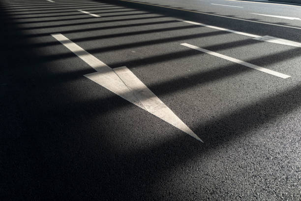 Light and shadow on traffic signs on asphalt road