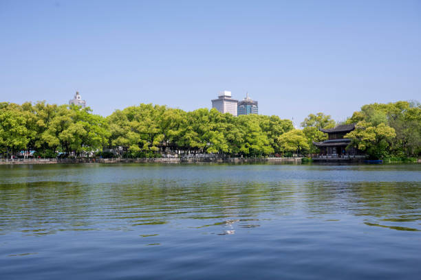 istock Modern urban green park by the lake in spring 2151498926
