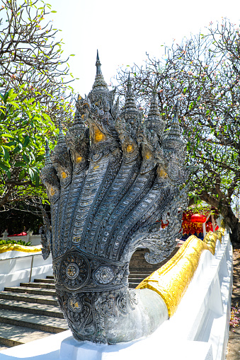 Centuries-year-old Naga statue at the railing of an old Buddhist temple that enshrines the Buddha's footprint of the Buddha symbol of holiness Of Buddhists : Saraburi Province, Thailand