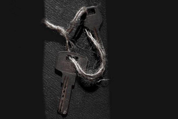Two rusty keys tied together with a rope