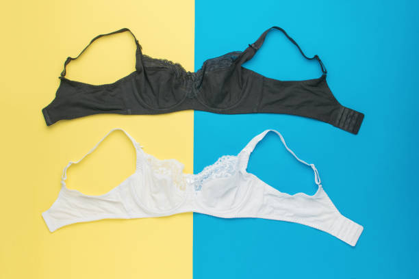 istock Black and white women's bras on a yellow and blue background. 2151503585