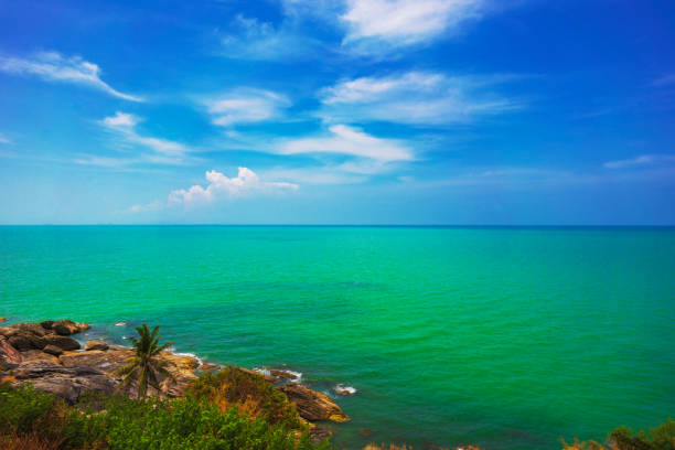Seascape and coastline under a cloudy sky.