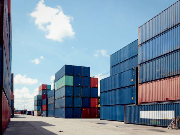 istock Stack of cargo container box in logistic shipping yard whit blue sky on sunny day 2151508141