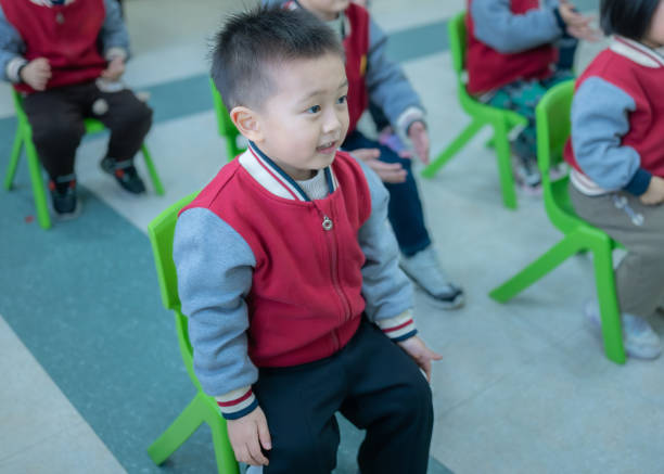 A happy little boy performs for his mother