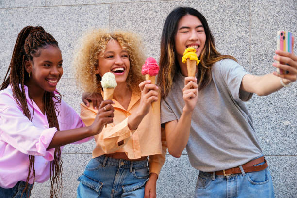 istock Three multiracial happy friends with ice creams taking a selfie in summer. 2151514419