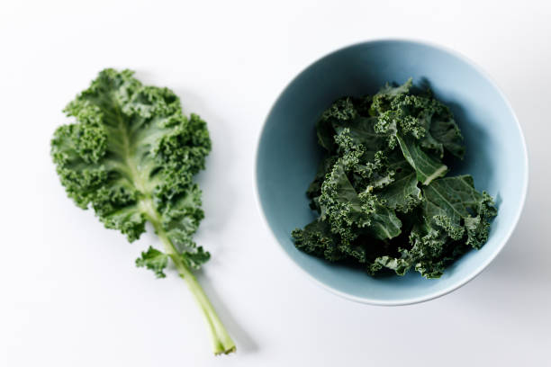 istock Fresh green Kale leaf salad vegetable on white background 2151516805