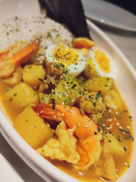 istock Shrimps in curry sauce and rice on a plate. horizontal view from above 2151517381