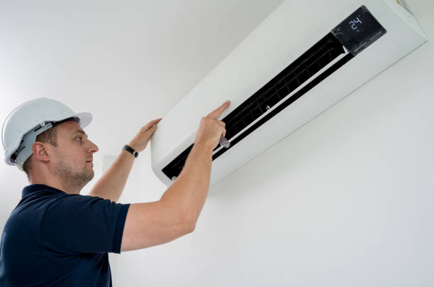 istock technician cleans air conditioner system in a modern apartment. 2151517647