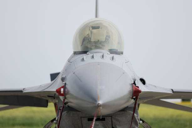 istock Fighter jet in parking position with red remove before flight ribbon attached 2151519392