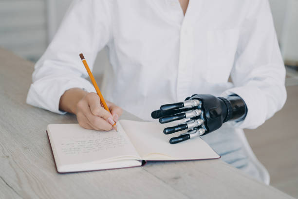 Thoughtful woman with a bionic arm pens ideas in a notebook, blending traditional writing with modern tech.