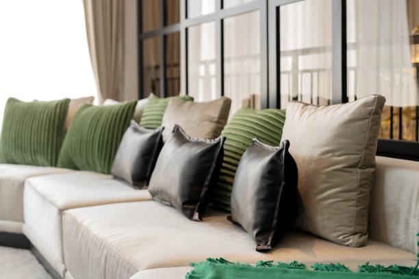 Luxury hotel lounge with stylish sofa, decorative pillows and two cube-shaped stools covered in cowhide. Mexico.