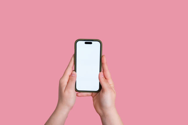 istock Woman holding smartphone with blank screen on pink background 2151524025