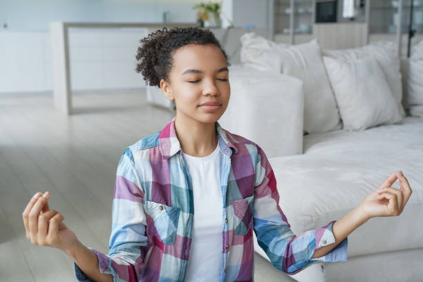 istock Peaceful young person practicing meditation, finding balance in a serene home setting. 2151525968