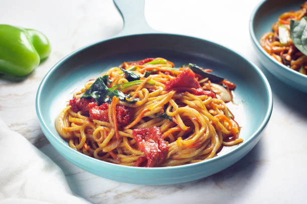 istock noodles with tomatoes and garlic with tomato sauce 2151526435