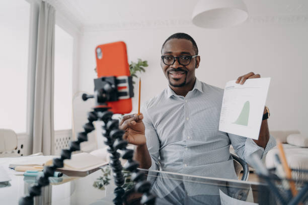 istock Confident businessman presenting financial data while recording for a professional vlog. 2151526442