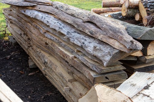 A pile of wooden planks. Stack of cut boards. close-up at a lumber warehouse