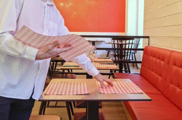 The Latina owner of a restaurant in Bogota, Colombia, prepares to open the doors and begin serving customers.